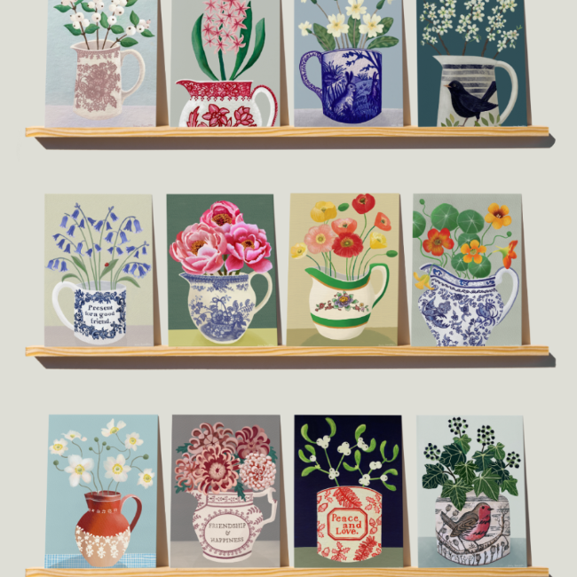 Shelves with decorative cards featuring floral designs and mugs on a light gray background