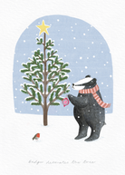Illustration of a badger decorating a Christmas tree with a star, surrounded by snowflakes.