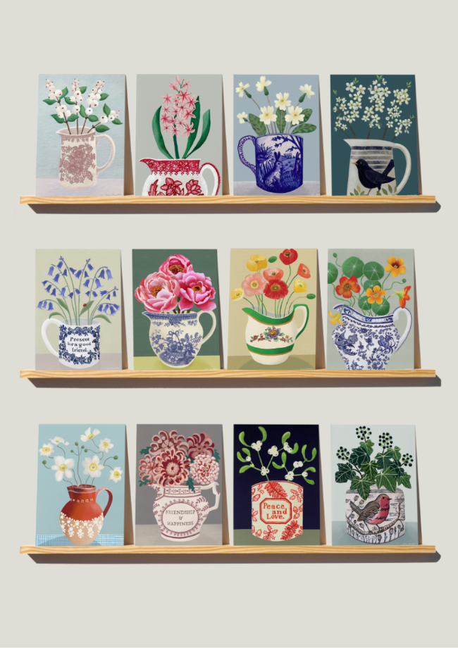 Shelves with decorative cards featuring floral designs and mugs on a light gray background